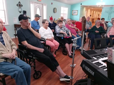 Residents enjoying a live music performance in a common area