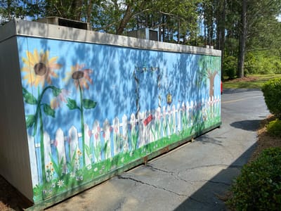 Colorful mural on the side of a facility building