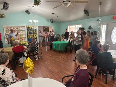 Residents and family gathered in a common area celebration