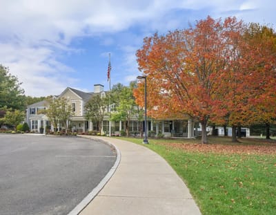 Exterior view of Allerton House with colorful autumn tree