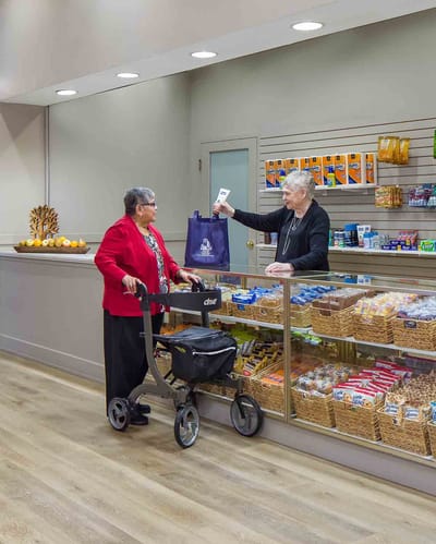 Resident interacting with staff in a store area.