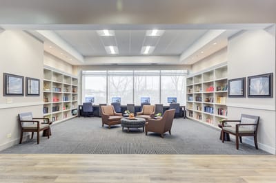 Comfortable common area with seating and bookshelves.