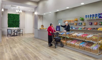 Resident interacting with staff in a common area.