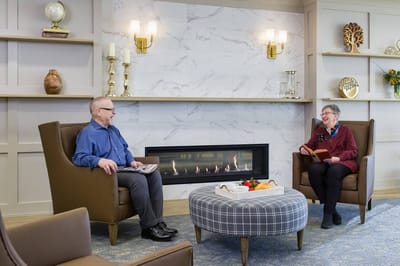 Residents enjoying conversation in a cozy common area.
