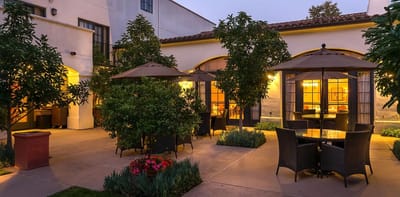 Outdoor seating area with tables and umbrellas