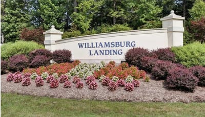 Signage for Williamsburg Landing surrounded by flowers