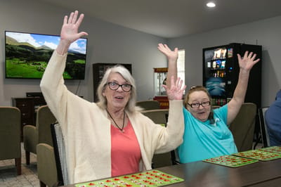 Residents happily participating in a bingo game