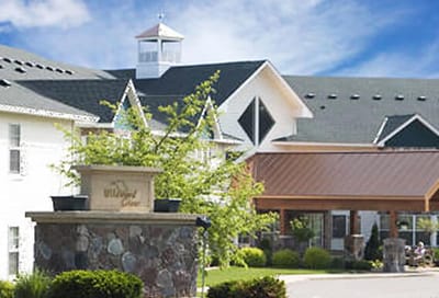 Exterior view of Wildwood Grove facility with landscaped entrance