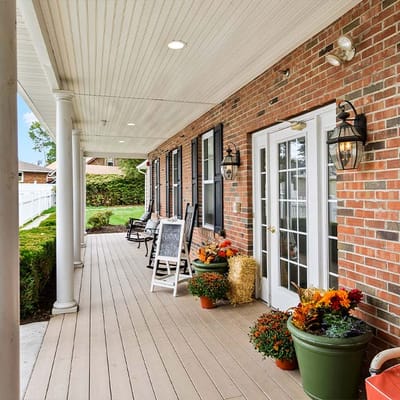 Welcoming outdoor porch with seating and plants.