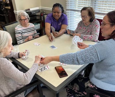 Residents engaged in a card game activity.