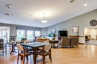 Bright common area with seating and a decorative clock