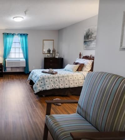 Cozy bedroom with a chair and bright curtains