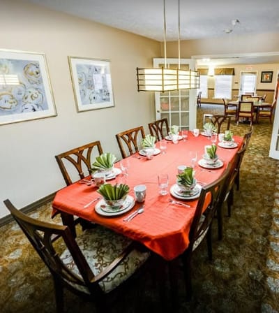 Dining room set up for a meal with elegant table settings