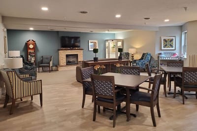 Bright common area with seating and a fireplace