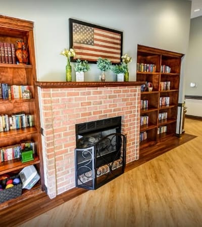 Cozy common area with a fireplace and shelves
