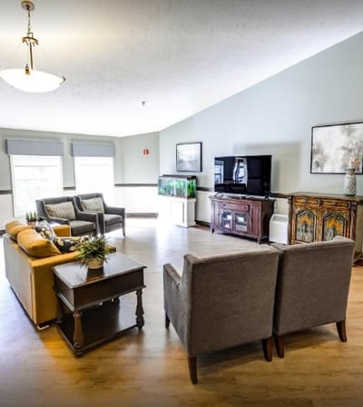 Bright common area with seating and aquarium