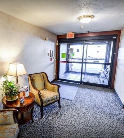 Bright lobby area with seating and exit door