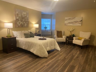 Cozy resident room with a bed and seating area