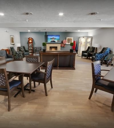 Bright and inviting common area with seating and a fireplace