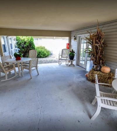 Covered outdoor seating area with plants and decorations