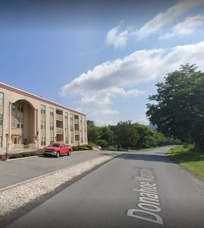 Exterior view of a senior living facility with landscaping