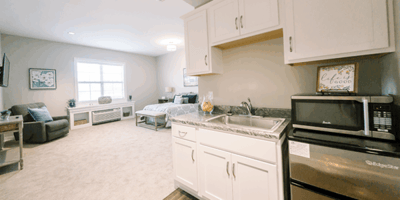 Spacious resident room with kitchenette and living area