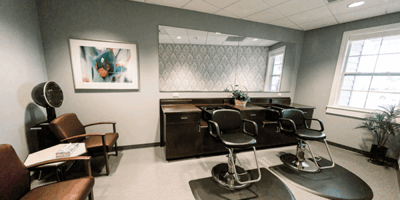 Beauty salon area with styling chairs and decor