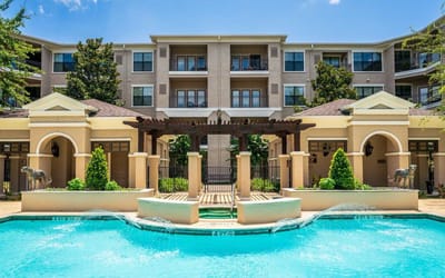 Outdoor pool area with fountain in front of the building