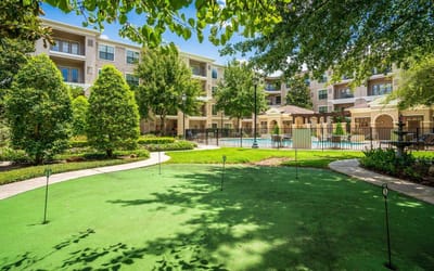 View of outdoor space with greenery and pool area