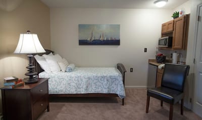 Cozy resident room with bed and kitchenette