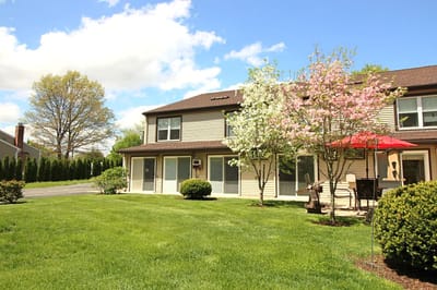 Exterior view of a senior living facility with gardens
