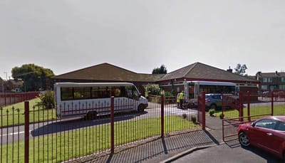 MHA Portland House, independent living — Senior living facility entrance with parking and landscaped area