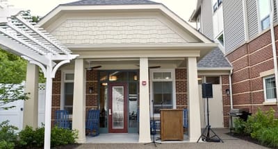 Entrance of a senior living facility with seating area