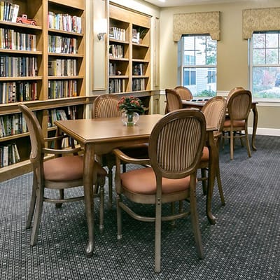 Cozy reading space with bookshelves and tables