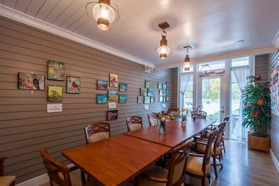 Bright common area with artwork and a large table