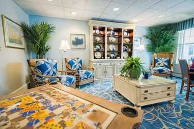 Bright common area with comfortable seating and puzzle table