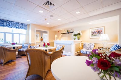 Bright common area with comfortable seating and floral decor