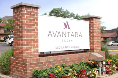 Signage for Avantara Elgin with flowers