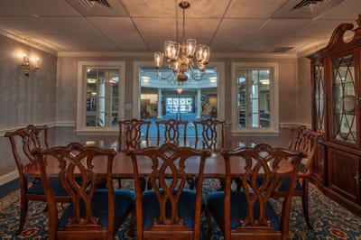 Elegant dining room with a long table and chandelier