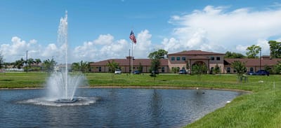 Exterior view of the assisted living facility with a fountain