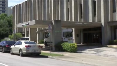 Front entrance of Cathedral Care facility with vehicles