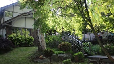 Exterior view of Crystal Falls Adult Family Home surrounded by greenery