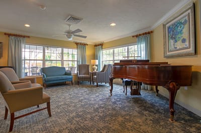 Bright common area with seating and a piano