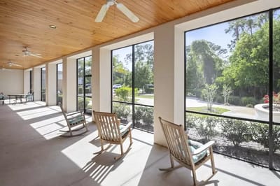 Sunny porch area with rocking chairs and garden view