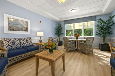 Brightly furnished common area with seating and plants