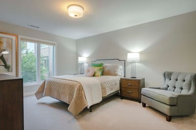 Cozy resident room with a bed and chair