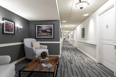 Bright interior hallway with chairs and artwork
