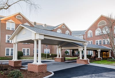 Entrance of a senior living facility with a covered portico