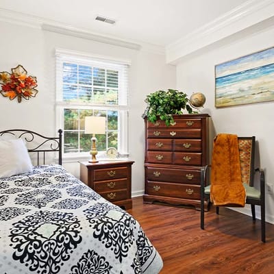 Cozy resident room with a bed and dresser