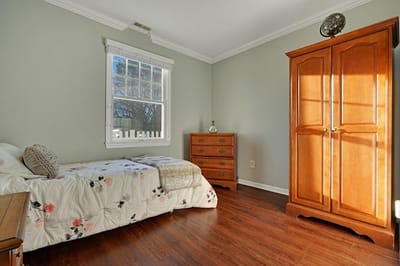 Cozy private room with floral bedding and wooden furniture